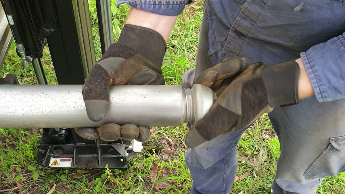 Field technician handling undisturbed soil sample tube on site